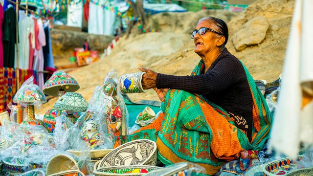 free-photo-of-a-woman-sitting-on-a-rock-with-a-basket-of-pottery.jpeg