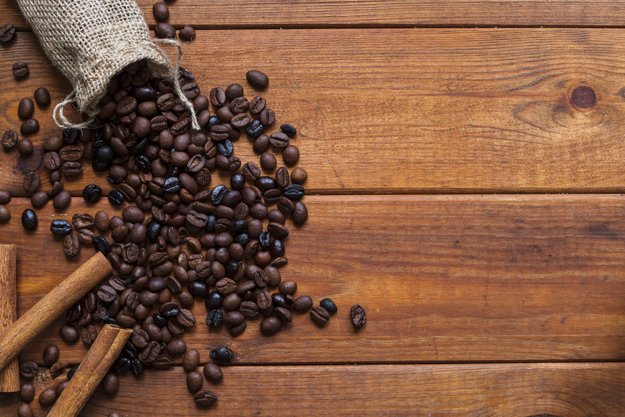 cinnamon-near-spilled-coffee-beans_23-2147764898.jpg
