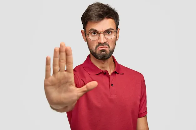 it-s-forbidden-angry-displeased-young-male-frowns-face-shows-stop-gesture-keeps-palm-front-tries-prevent-himeself-from-something-bad-unpleasant-wears-casual-t-shirt-isolated-white_273609-16264.webp