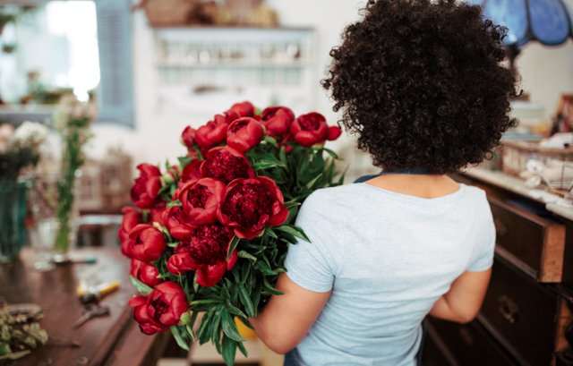 rear-view-african-female-florist-with-bunch-red-flowers.jpg