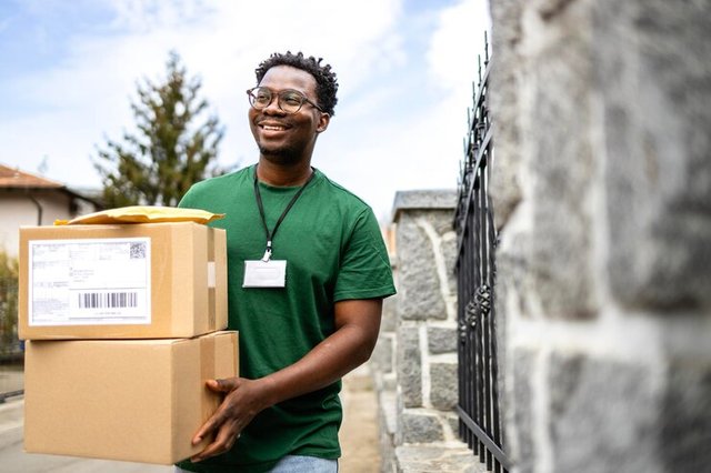 happy-courier-delivering-parcel-mail-residential-area_308072-7075.jpg