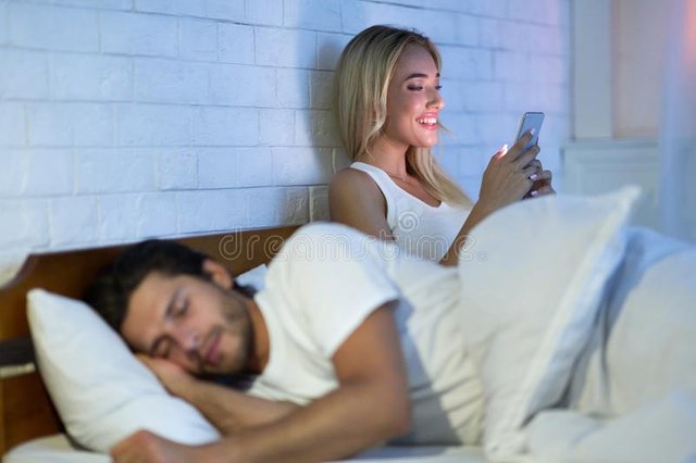 cheating-wife-chatting-cellphone-her-husband-sleeping-bedroom-night-low-light-selective-focus-cheating-wife-159956907.jpg