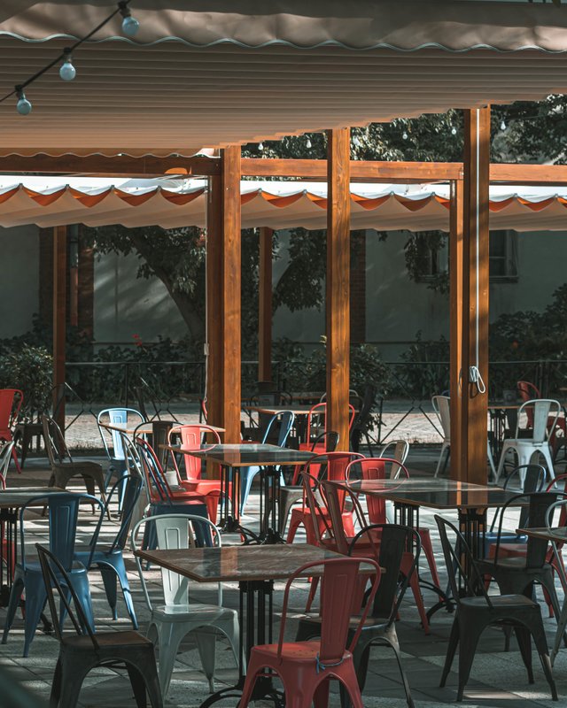 outdoors-empty-cafe-tables-chairs-sunny-day.jpg