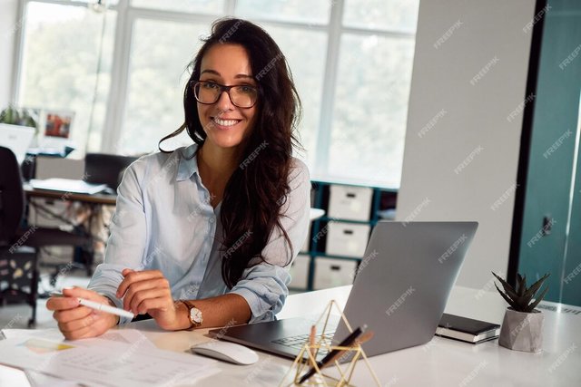 sincere-business-woman-glasses-is-working-laptop-office-smiling-camera_731383-17.jpg