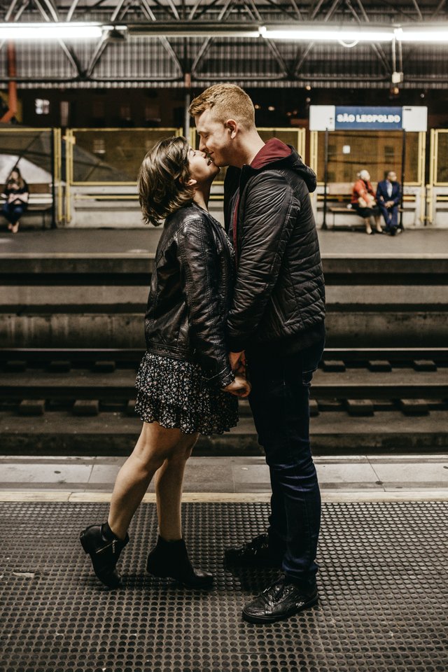 photo-of-couple-kissing-while-standing-on-train-station-3121473.jpg