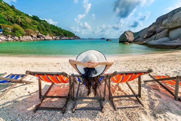 woman-with-hat-sitting-chairs-beach-beautiful-tropical-beach-woman-relaxing-tropical-beach-koh-nangyuan-island_335224-1111.jpg