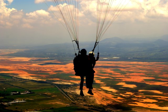 silhouette-of-person-on-parachute-during-sunset-3702806.jpg