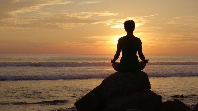 woman-meditation-on-an-ocean-side-rock-royalty-free-image-1616630391_.jfif