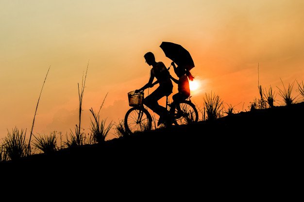 brother-with-sister-riding-bikes-at-sunset_2379-605.jpg