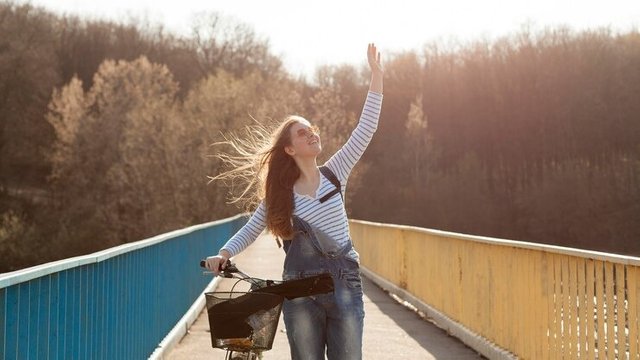 carefree-woman-posing-with-bicyc.jpg