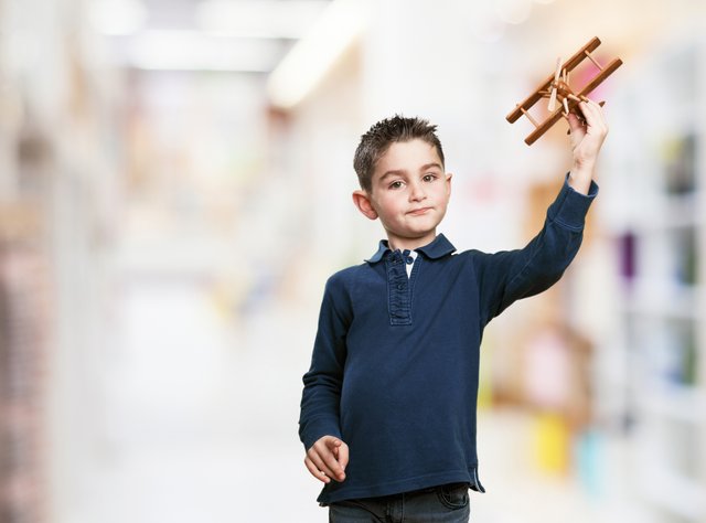 little-boy-playing-with-wooden-plane.jpg