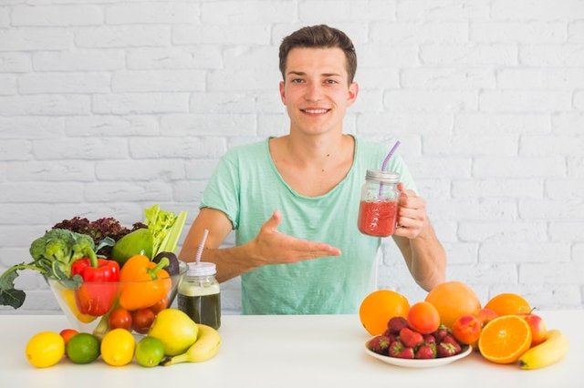 smiling-man-holding-red-smoothie.jpg