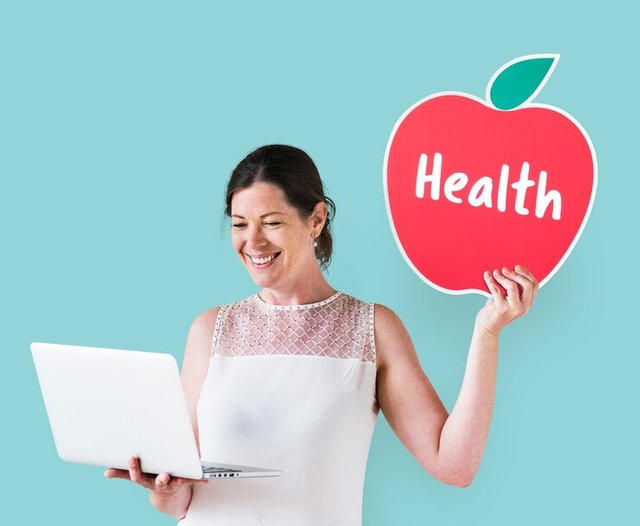 woman-holding-health-icon-using-laptop_53876-65372.jpg