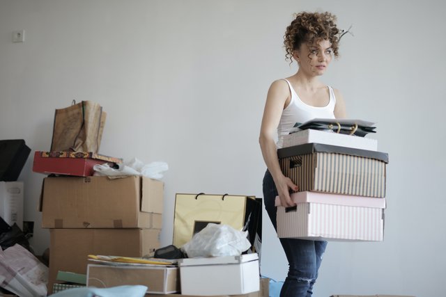 concentrated-woman-carrying-stack-of-cardboard-boxes-for-3791617.jpg