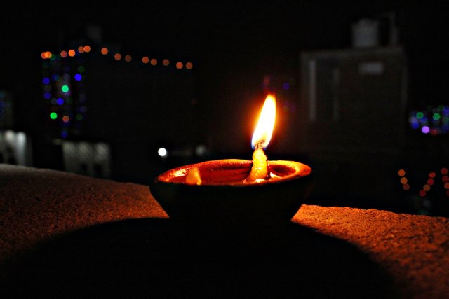 hindu festival Diwali. Isolated single diya with brilliant bokeh.JPG