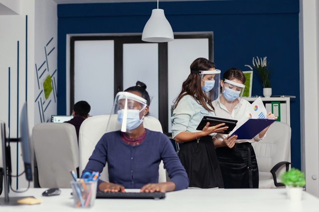 colleagues-doing-good-work-together-holding-tablet-pc-weaing-face-mask-covid19-multiethnic-business-team-working-respecting-social-distance-global-pandemic-with-coronavirus_482257-9853.jpg