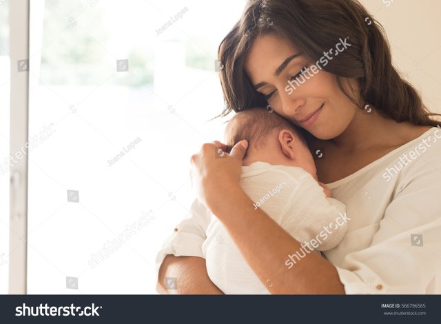 stock-photo-pretty-woman-holding-a-newborn-baby-in-her-arms-566796565.jpg