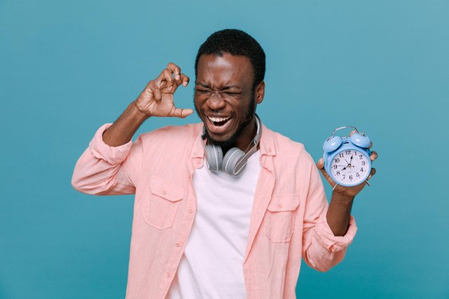annoyed-holding-alarm-clock-young-africanamerican-guy-wearing-headphones-neck-isolated-blue-background.jpg
