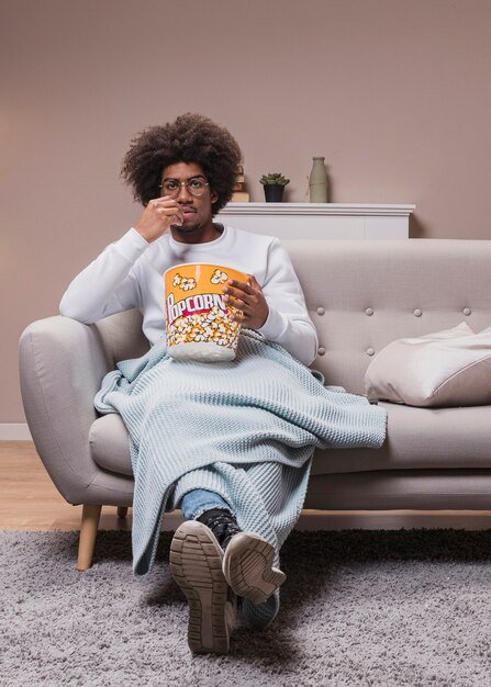 male-eating-popcorn-couch_23-2148405712.jpg