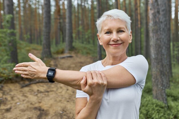 portrait-short-haired-retired-female-wearing-whit-t-shirt-smart-watch-her-wrist-track-progress-running_343059-4091.jpg