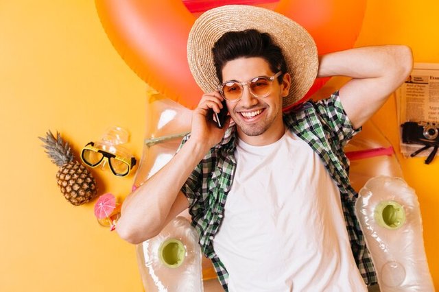 attractive-brunette-man-plaid-shirt-white-t-shirt-with-smile-talking-phone-guy-hat-sunglasses-lying-inflatable-mattress_197531-15520.jpg