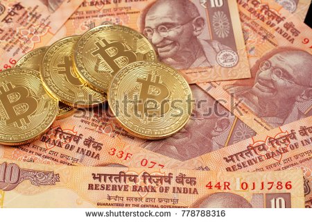 stock-photo-a-close-up-image-of-bitcoins-with-indian-rupee-notes-778788316.jpg