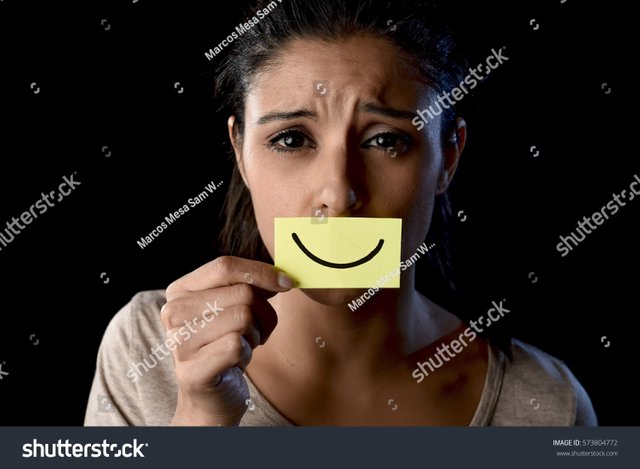 stock-photo-young-beautiful-latin-sad-and-depressed-latin-girl-holding-paper-hiding-her-mouth-behind-a-fake-573804772.jpg