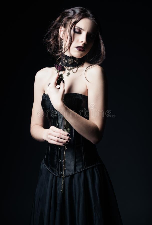 dramatic-portrait-beautiful-sad-goth-girl-holding-withered-rose-hands-125166232.jpg