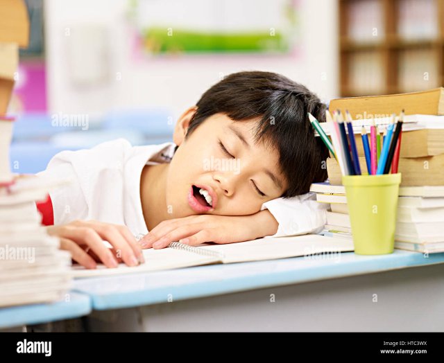 tired-and-exhausted-asian-primary-school-student-falling-asleep-while-HTC3WX.jpg