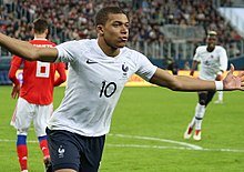 220px-Kylian_Mbappe_celebrating_-_March_2018.jpg