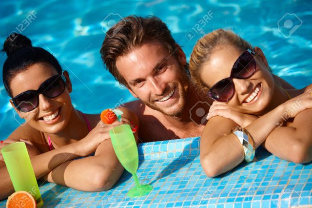 12918695-happy-young-people-on-holiday-smiling-in-swimming-pool-.jpg
