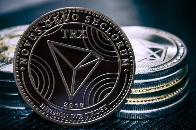 The-coin-cryptocurrency-Tron-on-the-background-of-a-stack-of-coins.-Image-696x464.jpg