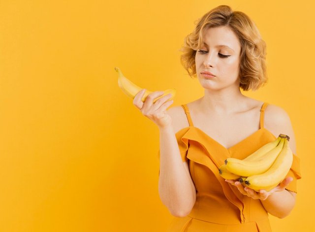 portrait-woman-holding-bananas_23-2148450385.jpg