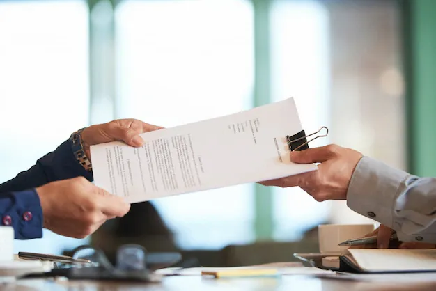 closeup-hands-passing-contract-unrecognizable-businessman_1098-19612.webp