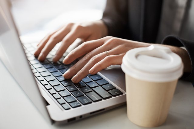 closeup-woman-working-laptop-while-sitting-office.jpeg