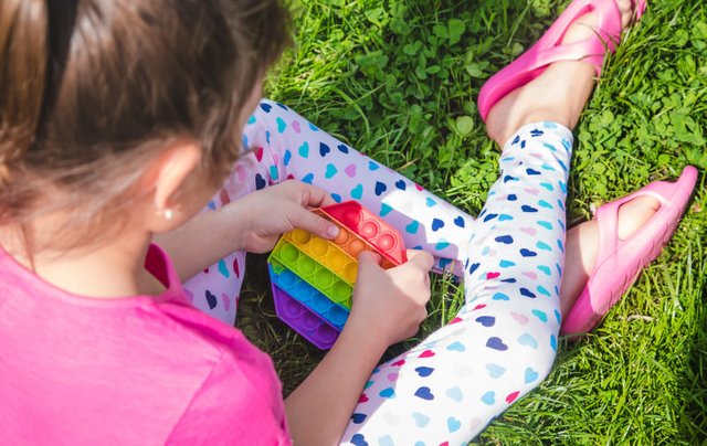 colorful-antistress-sensory-toy-fidget-push-pop-it-child-hands-selective-focus-nature-1-1-768x485.jpg