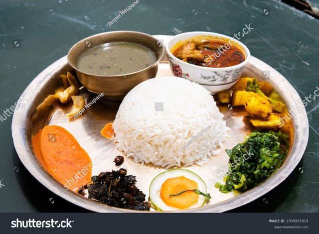 stock-photo-traditional-nepali-thakali-dish-of-rice-lentils-curry-and-chutney-aka-daal-bhaat-and-tarkari-2339801013.jpg