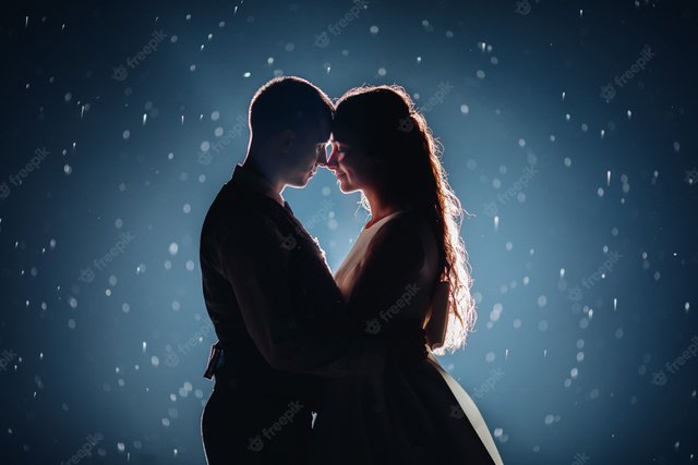 stock-photo-romantic-just-married-couple-hugging-face-face-against-illuminated-dark-background-with-glowing-sparkles-around_132075-10378.jpg