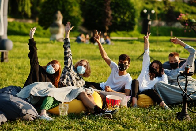 young-multi-ethnic-group-people-watching-movie-poof-open-air-cinema-wear-mask-during-covid-coronavirus-quarantine.jpg