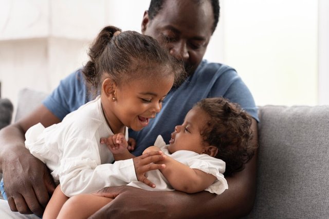 man-holding-his-daughters-his-arms_23-2149022836.jpg