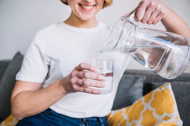 crop-woman-pouring-water.jpg