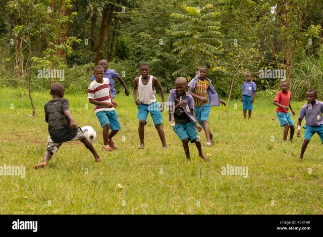 school-boys-playing-football-bogodi-uganda-africa-R5RTAK.jpg