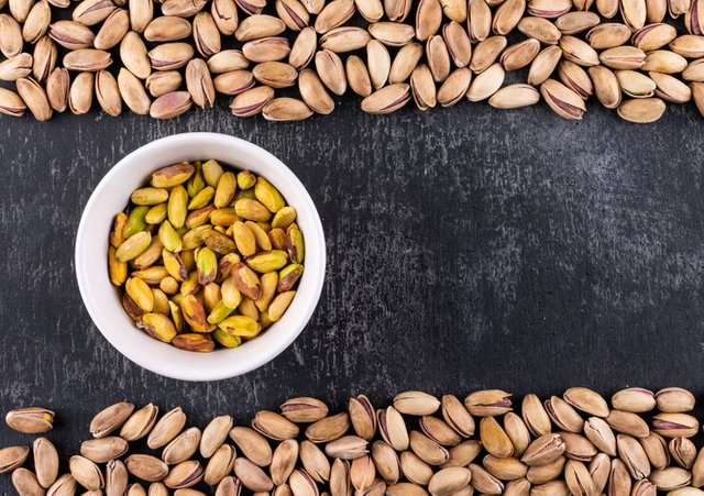 top-view-pistachios-bowl-gray-texture-with-copy-space-horizontal_176474-1328.jpg