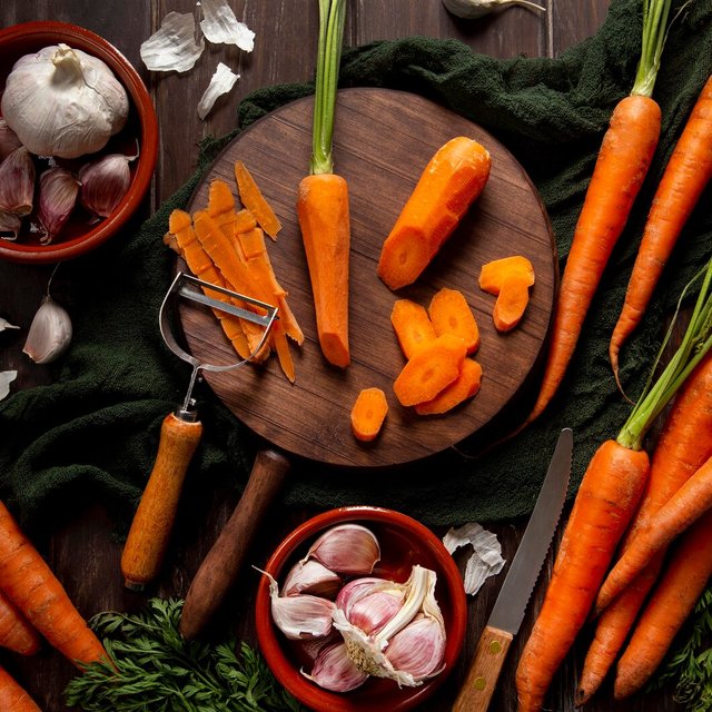 top-view-carrots-with-peeler-garlic_23-2148622441.jpg