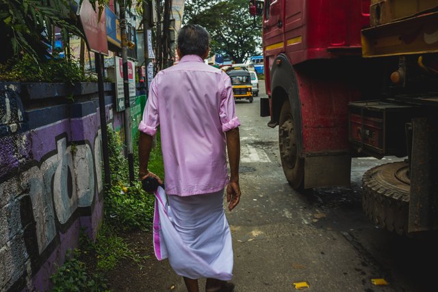 man-walking-though-streets-india.jpg