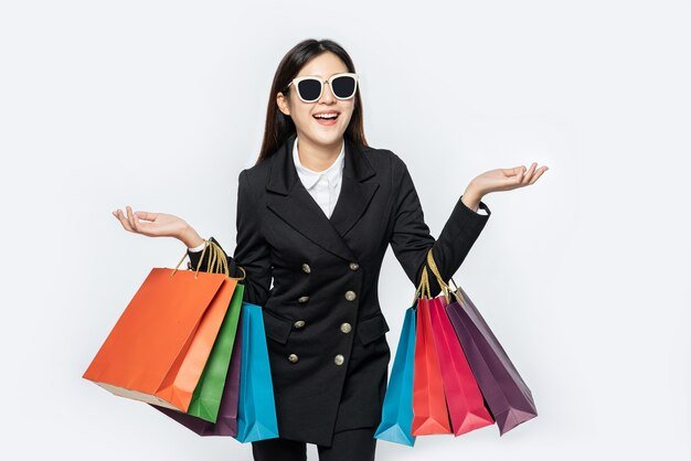 woman-wearing-dark-clothes-glasses-along-with-many-bags-go-shopping_1150-27688.jpg