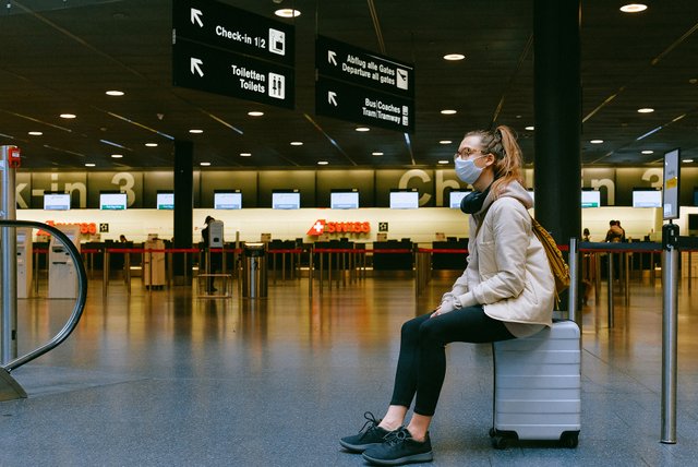 Woman-Sitting-on-Luggage-Mask-Pexels.jpg