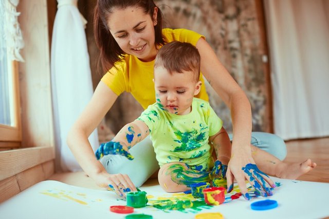 mother-with-son-painting-big-paper-with-their-hands_8353-5132.jpg