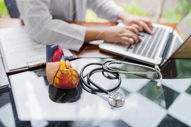 doctor-consult-patient-laptop-with-anatomical-model-human-heart-cardiologist-supports-heart-online-doctor-appointment_1715-9902.jpg