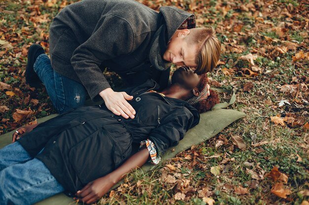 guy-help-woman-afro-girl-is-lying-unconscious-providing-first-aid-park_1157-40365.jpg